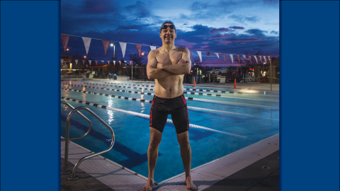 Gavin Maitland poses by a pool in his swimsuit