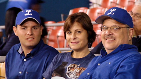 Juan Battle and his family in the stands at a baseball game. 