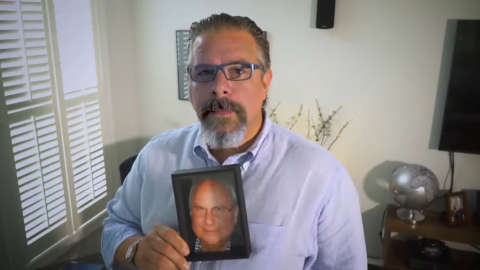 Sam Polley with a photo of his father Neill