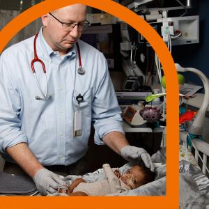 Image of physician caring for infant in the NICU