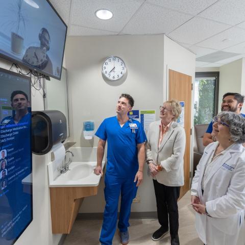 medical staff are looking at a screen
