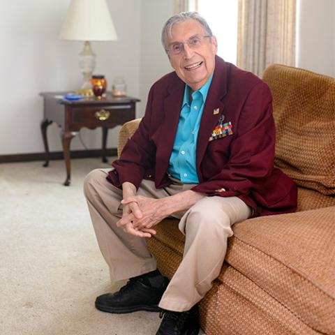 Edward Wise sits on a couch looking at camera