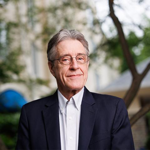 a man standing in front of the camera posing for his headshot