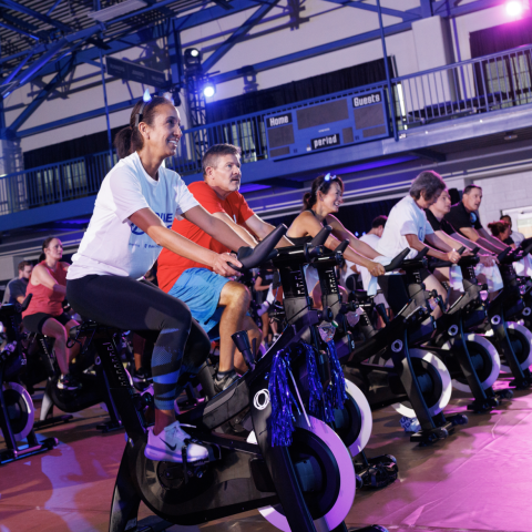 an image of a group of people riding stationary bikes at the Duke Rides event
