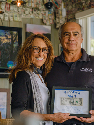 Mojos owners John and Andrea Pitera in their restaurant with plaque 