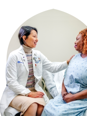 Xunrong Luo, MD, PhD, with a patient
