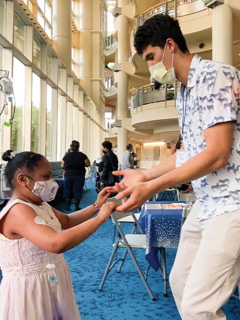 an image of a girl and a man wearing masks at an event