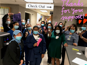 A large group of masked nurses on a ward thanking donors for leggings. Photo is marked "thank you for your support"