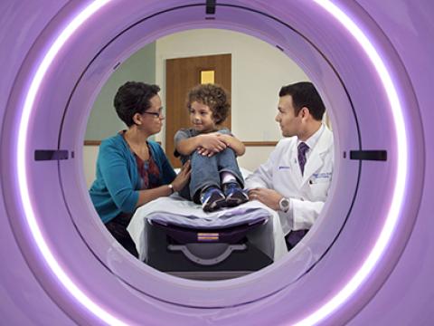 Patient and physician framed by CT scanner