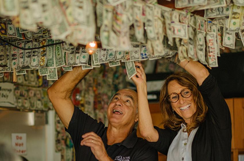 John and Andrea Pitera, the previous owners of Mojo’s on the Harbor, removing money from the restaurant ceiling