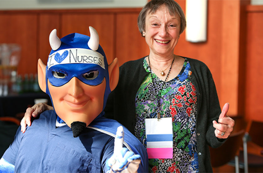 A member of the Duke Nursing Alumni Council with the Duke Blue Devil mascot